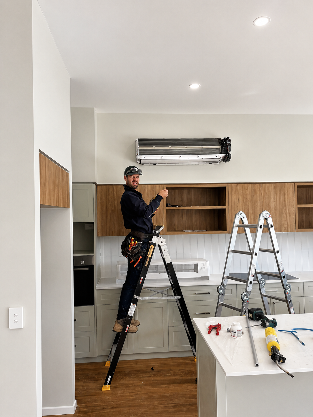 James (Jimmy) installing a split-system air conditioner on-site